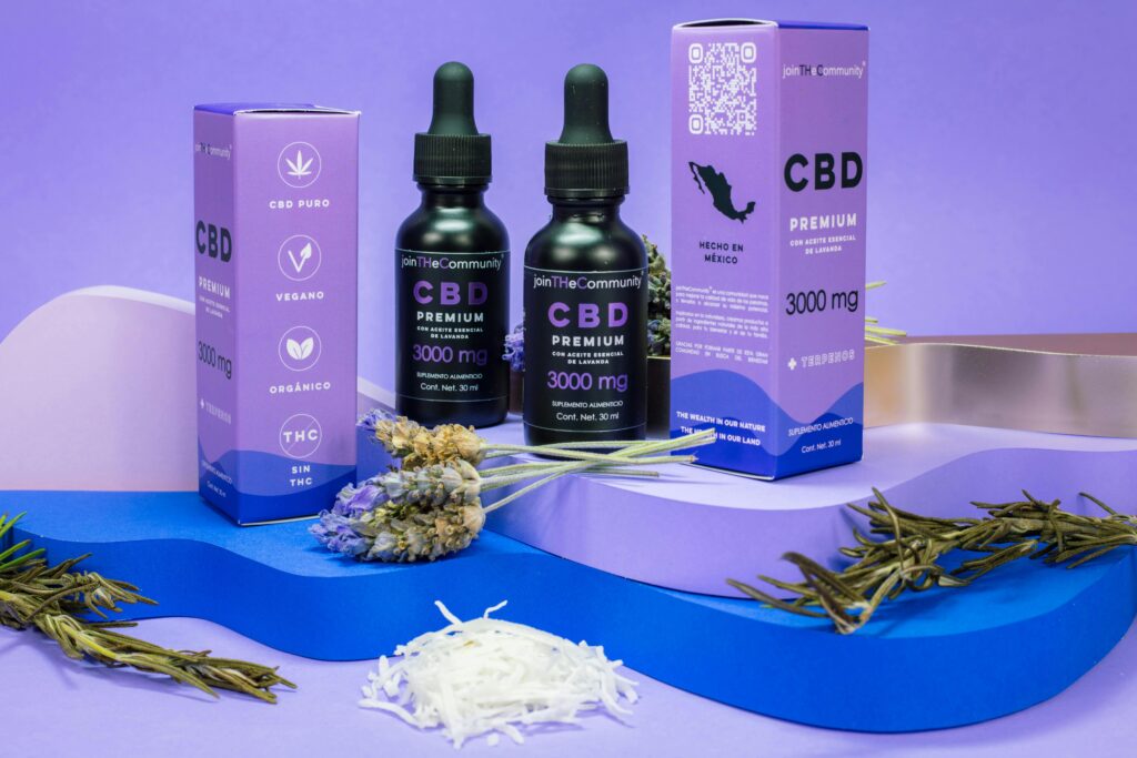 Lavender CBD oil bottles against a vibrant purple backdrop showcasing product packaging and herbs.